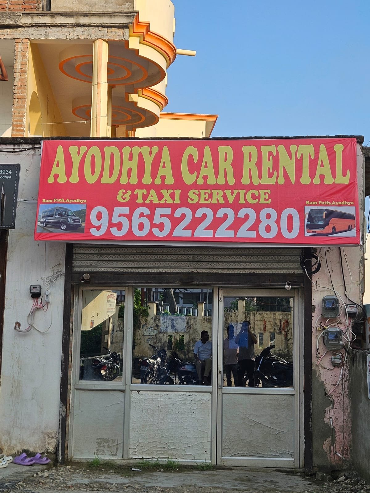 Ayodhya Car Rental & Taxi Service office storefront with contact number